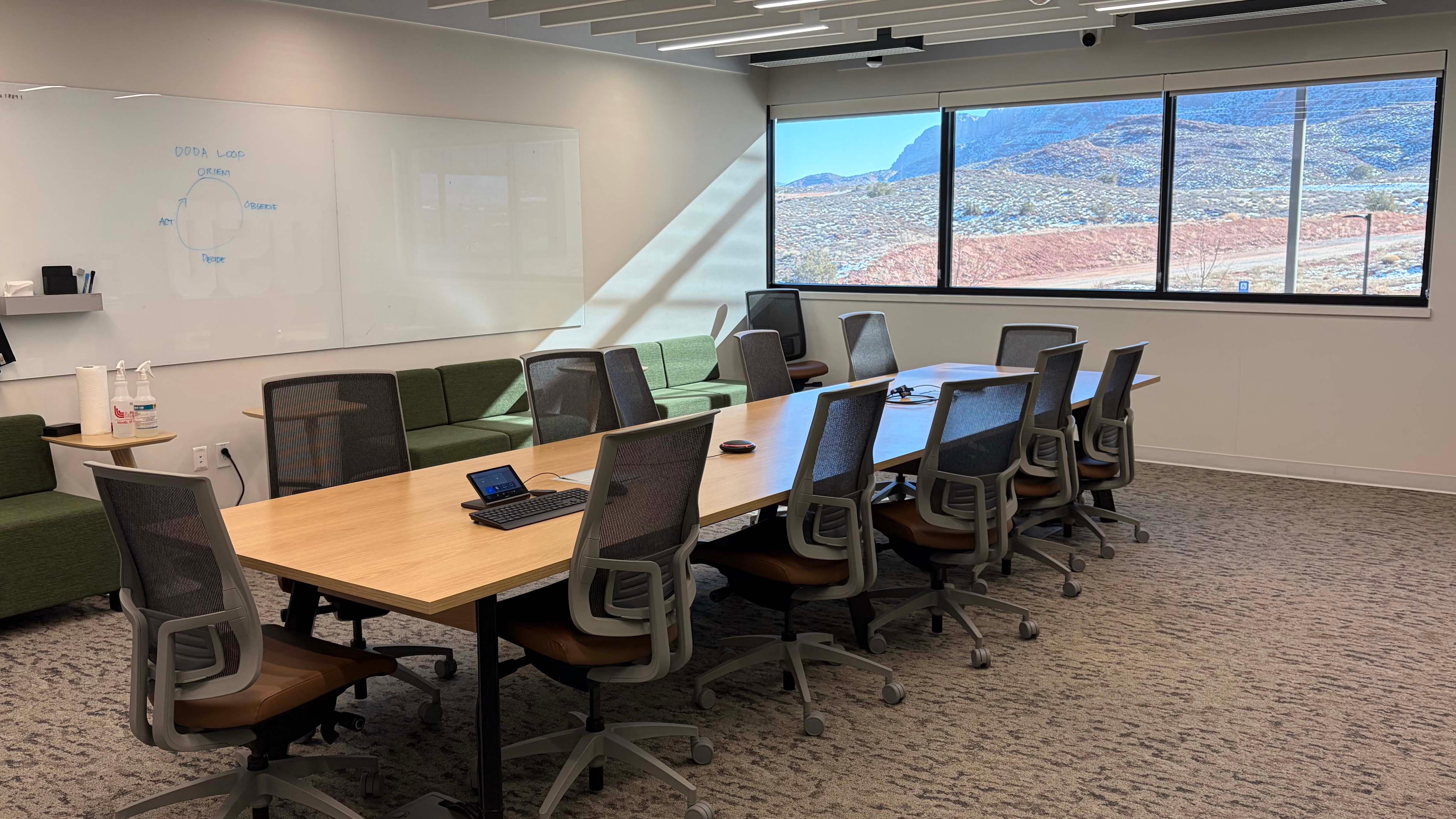 Conference room showing a central table and 12 chairs circling the table